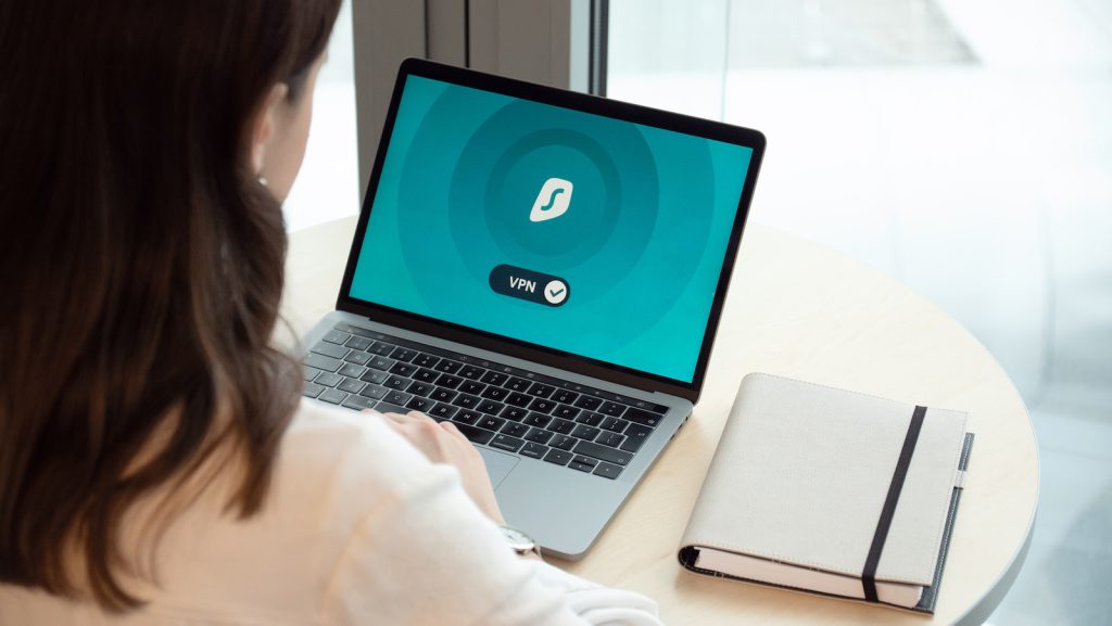 woman in white long sleeve shirt using macbook pro setting up new website for her business